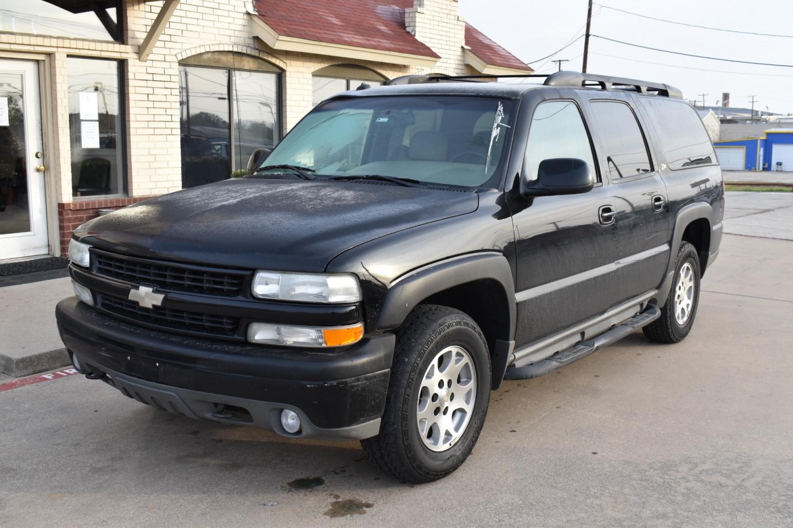 2003 Black /Beige Chevrolet Suburban 1500 4WD (3GNFK16Z13G) with an 5.3L V8 OHV 16V FFV engine, 4-Speed Automatic Overdrive transmission, located at 5925 E. BELKNAP ST., HALTOM CITY, TX, 76117, (817) 834-4222, 32.803799, -97.259003 - [Scene: A picturesque suburban neighborhood on a sunny day. The camera pans through lush lawns and beautiful homes.] Narrator (V.O.): Welcome to the heart of the suburbs, where life is all about family, adventure, and making memories that last a lifetime. [Cut to a driveway, where a well-maintaine - Photo#1