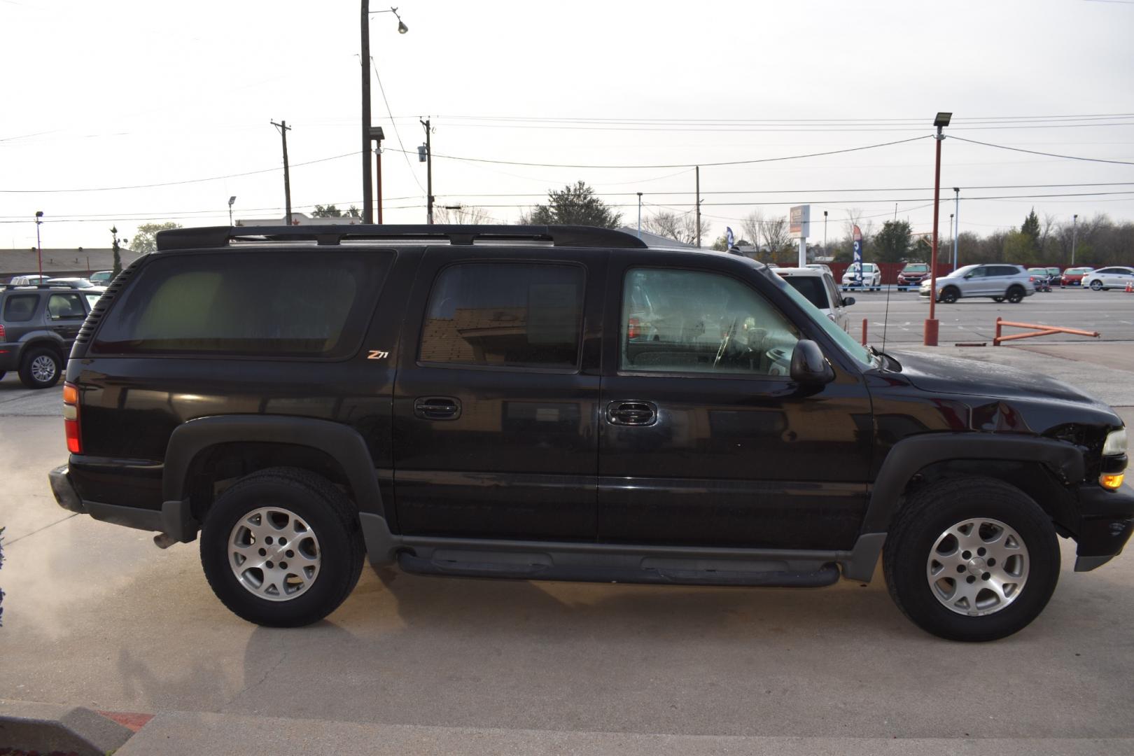 2003 Black /Beige Chevrolet Suburban 1500 4WD (3GNFK16Z13G) with an 5.3L V8 OHV 16V FFV engine, 4-Speed Automatic Overdrive transmission, located at 5925 E. BELKNAP ST., HALTOM CITY, TX, 76117, (817) 834-4222, 32.803799, -97.259003 - [Scene: A picturesque suburban neighborhood on a sunny day. The camera pans through lush lawns and beautiful homes.] Narrator (V.O.): Welcome to the heart of the suburbs, where life is all about family, adventure, and making memories that last a lifetime. [Cut to a driveway, where a well-maintaine - Photo#3