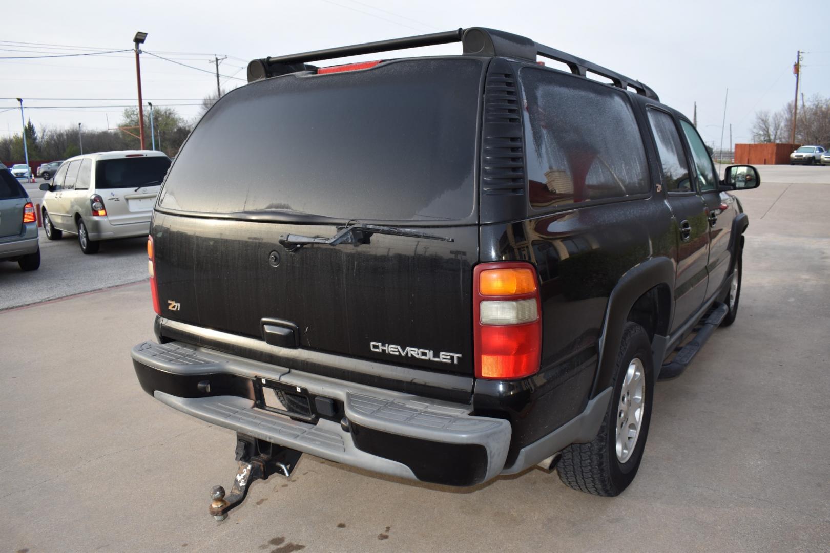 2003 Black /Beige Chevrolet Suburban 1500 4WD (3GNFK16Z13G) with an 5.3L V8 OHV 16V FFV engine, 4-Speed Automatic Overdrive transmission, located at 5925 E. BELKNAP ST., HALTOM CITY, TX, 76117, (817) 834-4222, 32.803799, -97.259003 - [Scene: A picturesque suburban neighborhood on a sunny day. The camera pans through lush lawns and beautiful homes.] Narrator (V.O.): Welcome to the heart of the suburbs, where life is all about family, adventure, and making memories that last a lifetime. [Cut to a driveway, where a well-maintaine - Photo#4