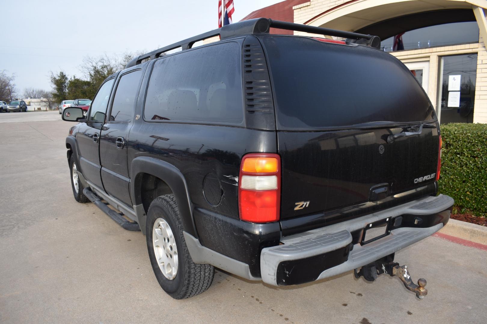 2003 Black /Beige Chevrolet Suburban 1500 4WD (3GNFK16Z13G) with an 5.3L V8 OHV 16V FFV engine, 4-Speed Automatic Overdrive transmission, located at 5925 E. BELKNAP ST., HALTOM CITY, TX, 76117, (817) 834-4222, 32.803799, -97.259003 - [Scene: A picturesque suburban neighborhood on a sunny day. The camera pans through lush lawns and beautiful homes.] Narrator (V.O.): Welcome to the heart of the suburbs, where life is all about family, adventure, and making memories that last a lifetime. [Cut to a driveway, where a well-maintaine - Photo#6