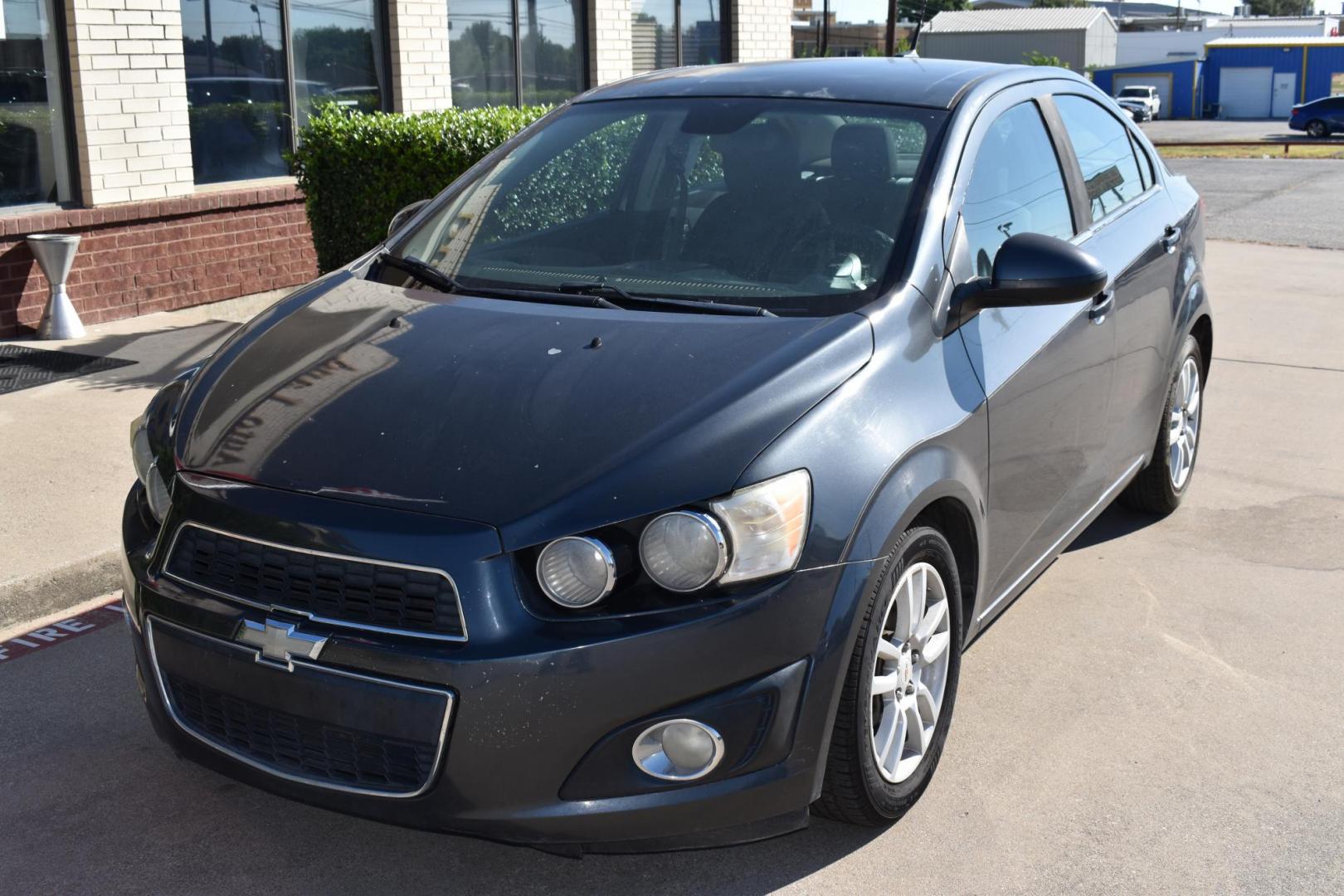 2012 Black /Gray Chevrolet Sonic (1G1JC5SH9C4) with an 4.1.8L engine, 6-Speed Automatic transmission, located at 5925 E. BELKNAP ST., HALTOM CITY, TX, 76117, (817) 834-4222, 32.803799, -97.259003 - The 2012 Chevrolet Sonic offers several benefits. Here are a few: 1. Fuel Efficiency: The Sonic is known for its impressive fuel efficiency, making it a cost-effective choice for daily commuting and long drives. 2. Compact Size: The Sonic's compact size makes it easy to maneuver in tight city stre - Photo#0