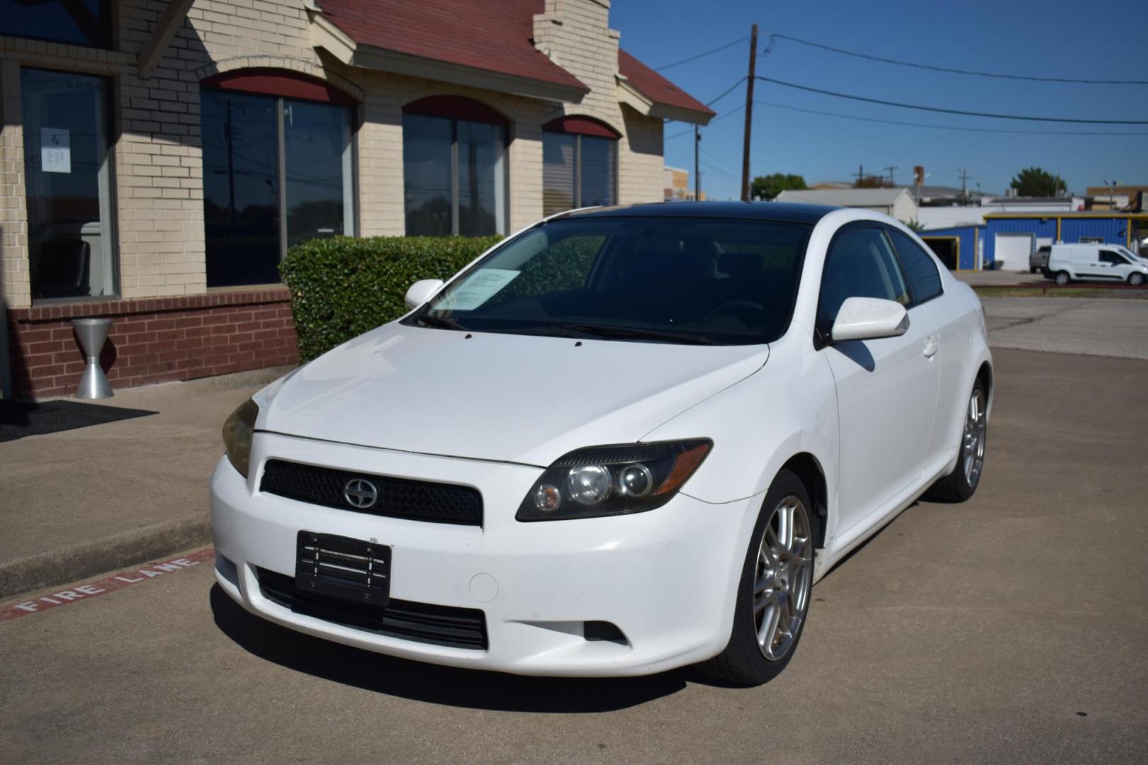 2008 White /Black Scion tC Sport Coupe (JTKDE167280) with an 2.4L L4 DOHC 16V engine, 4 SPEED AUTOMATIC transmission, located at 5925 E. BELKNAP ST., HALTOM CITY, TX, 76117, (817) 834-4222, 32.803799, -97.259003 - The 2008 Scion TC Sport Coupe could be an appealing choice if you’re looking for a budget-friendly, sporty, and customizable compact car with a reputation for reliability and fun-to-drive dynamics. Here’s why you might consider buying a 2008 Scion TC: 1. Sporty Design and Fun-to-Drive Attrac - Photo#1