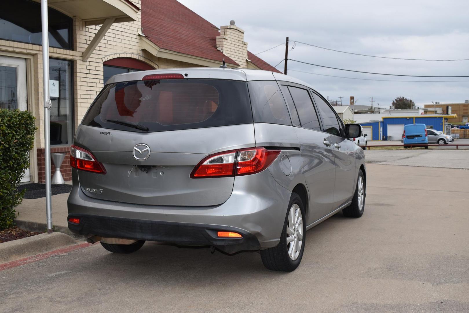 2013 Gray /Black Mazda MAZDA5 Sport AT (JM1CW2BL1D0) with an 2.5L L4 DOHC 16V engine, 5-Speed Automatic transmission, located at 5925 E. BELKNAP ST., HALTOM CITY, TX, 76117, (817) 834-4222, 32.803799, -97.259003 - Ah, the 2013 Mazda5! Here are some of its benefits: Versatility: The Mazda5 offers the practicality of a minivan with the maneuverability of a smaller car. Its sliding rear doors make it easy to access tight parking spaces and to get kids in and out. Seating: With seating for six, it has enoug - Photo#4